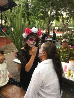 Woman putting on makeup for Day of the Dead San Miguel de Allende – Best Places In The World To Retire – International Living