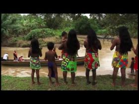 Embera Indians in Panama watch tourist ride a native cayco dugout canoe – Best Places In The World To Retire – International Living