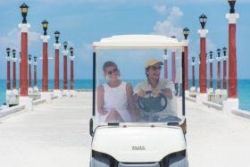 Riding a golf cart along the white sand beaches and pier near Peten development in Sisal, Yucatan, Mexico – Best Places In The World To Retire – International Living