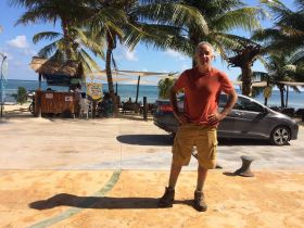 Chuck Bolotin standing in front of the beach at Mahahual, Mexico
