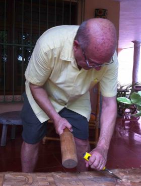 Denis Larsen carving a sign at Casa Hamaca, Valladolid, Mexico – Best Places In The World To Retire – International Living