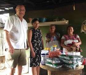 Denis Larsen delivering a dispensa to a family in Yucatan – Best Places In The World To Retire – International Living