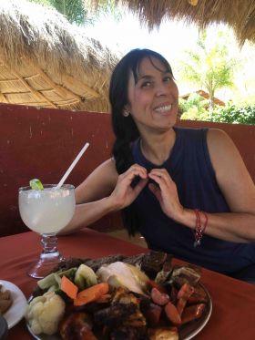 Jet Metier making a heart sign over food in Mexico