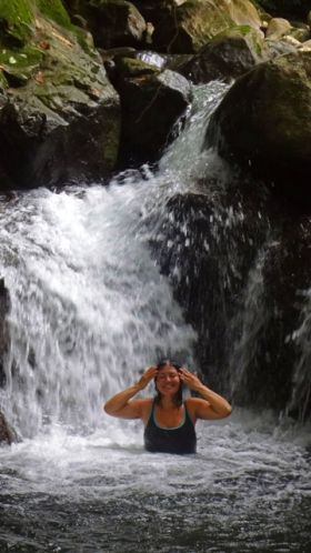 Waterfall with woman in Bocas del Toro, Panama – Best Places In The World To Retire – International Living